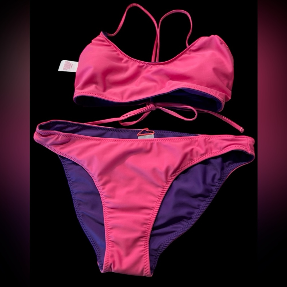 A No Boundries bikini that is reversible and can be pink or purple or a combo